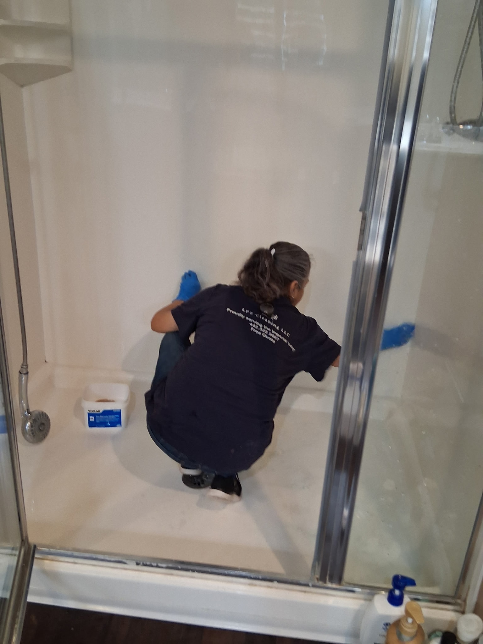 LPZ Cleaning team member deep cleaning a shower